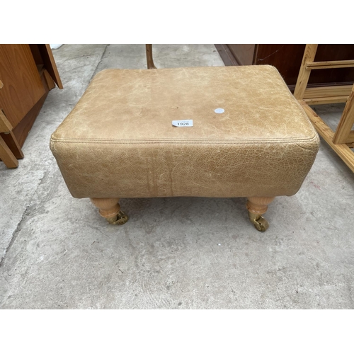 1928 - A MODERN LEATHER FOOT STOOL ON TURNED LEGS, COMPLETE WITH BRASS CASTORS