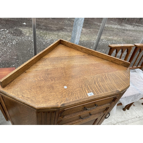 1937 - AN EARLY 20TH CENTURY OAK CORNER CABINET ENCLOSING THREE CUPBOARDS AND TWO DRAWERS, 42