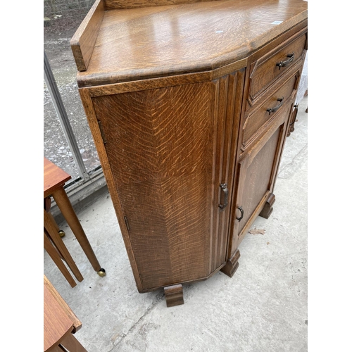 1937 - AN EARLY 20TH CENTURY OAK CORNER CABINET ENCLOSING THREE CUPBOARDS AND TWO DRAWERS, 42