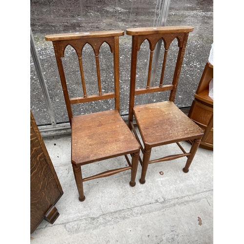 1938 - A PAIR OF VICTORIAN OAK HALL CHAIRS WITH GOTHIC STYLE BACKS