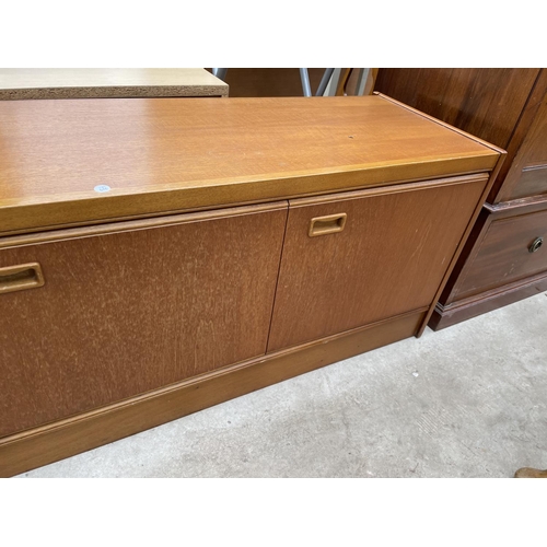 1955 - A RETRO JENTIQUE TEAK SIDEBAORD ENCLOSING THREE DRAWERS AND THREE CUPBOARDS