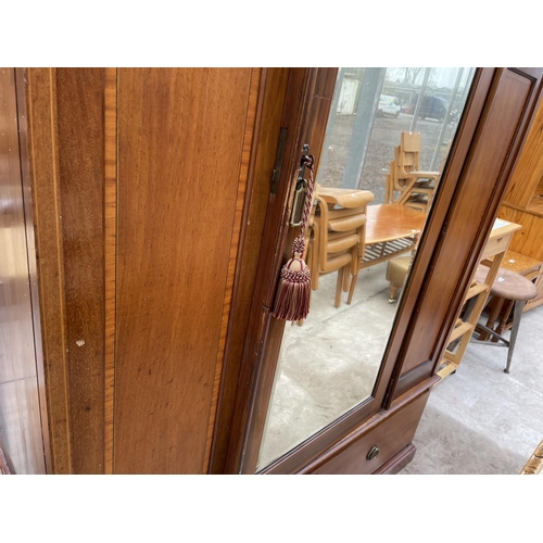 1956 - AN INLAID MAHOGANY WARDROBE WITH BEVEL EDGE MIRRORED DOOR AND LOWER DRAWER