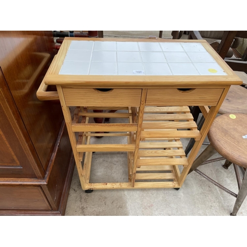 1957 - A MODERN PINE KITCHEN ISLAND ON CASTORS WITH WINE RACK AND TILED TOP