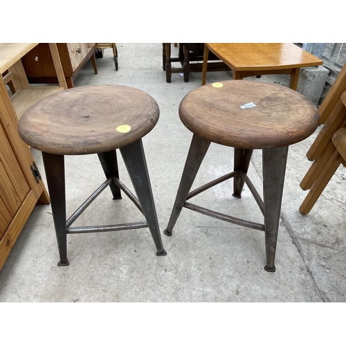 1958 - TWO CIRCULAR INDUSTRIAL STYLE STOOLS, STANDING ON POLISHED STEEL TAPERED LEGS