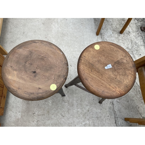 1958 - TWO CIRCULAR INDUSTRIAL STYLE STOOLS, STANDING ON POLISHED STEEL TAPERED LEGS