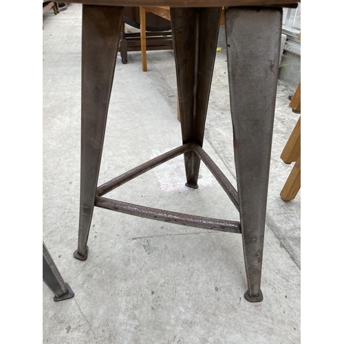 1958 - TWO CIRCULAR INDUSTRIAL STYLE STOOLS, STANDING ON POLISHED STEEL TAPERED LEGS