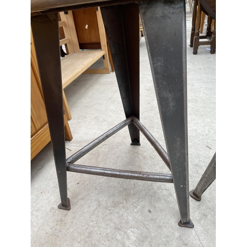 1958 - TWO CIRCULAR INDUSTRIAL STYLE STOOLS, STANDING ON POLISHED STEEL TAPERED LEGS