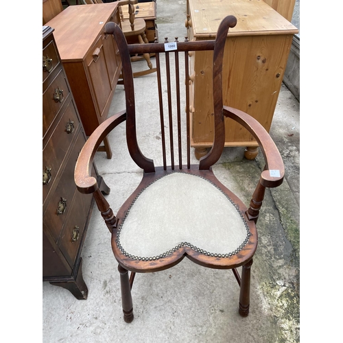 1980 - AN EDWARDIAN MAHOGANY ELBOW CHAIR WITH HEART SHAPED SEAT AND HARP STYLE BACK