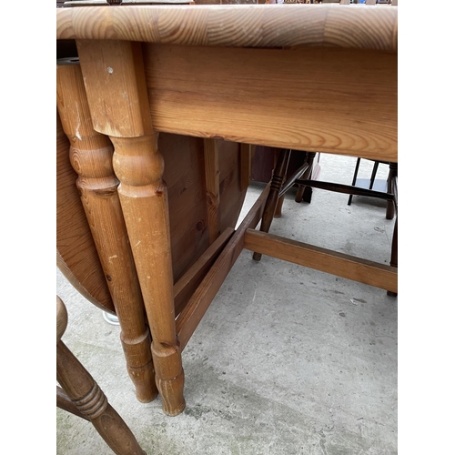 1988 - A PINE DROP-LEAF KITCHEN TABLE AND THREE CHAIRS