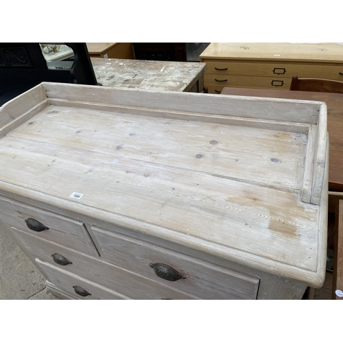 1995 - A VICTORIAN PINE GALLERY BACK CHEST OF TWO SHORT AND TWO LONG DRAWERS WITH LIMED FINISH