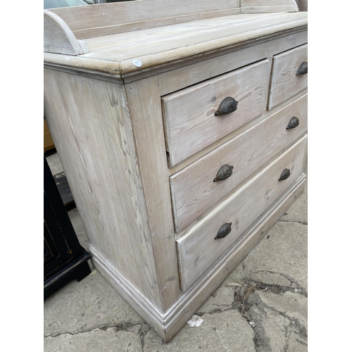 1995 - A VICTORIAN PINE GALLERY BACK CHEST OF TWO SHORT AND TWO LONG DRAWERS WITH LIMED FINISH