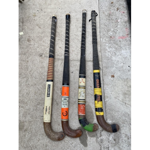 1323 - FOUR VINTAGE HOCKEY STICKS