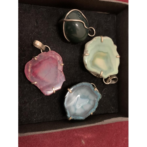 79 - A COLLECTION OF SIX COLOURFUL AGATE PENDANTS ON SILVER MOUNTS