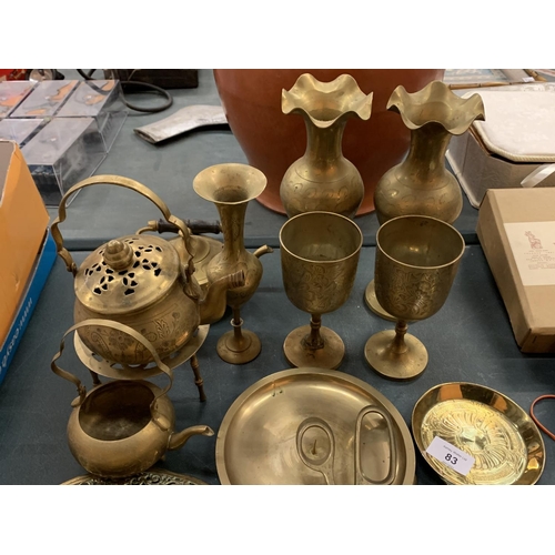 83 - A LARGE QUANTITY OF BRASS WARE TO INCLUDE VASES, GOBLETS, PLATES ETC