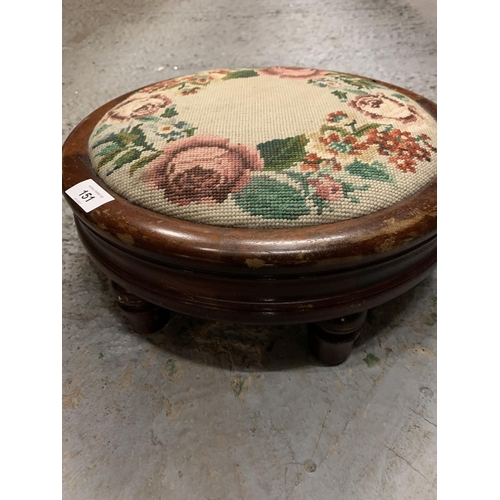 151 - A WOODEN CIRCULAR TAPESTRY TOPPED FOOTSTOOL