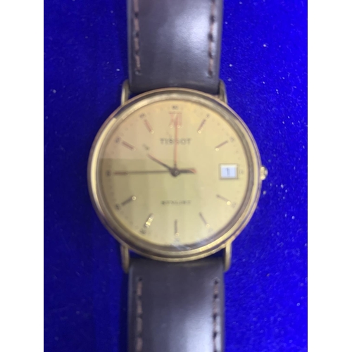 651 - A GENTS TISSOT WATCH WITH BROWN LEATHER STRAP