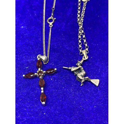 668 - SIX SILVER NECKLACES TWO WITH PENDANTS TO INCLUDE A RED STONE CROSS AND A WITCH