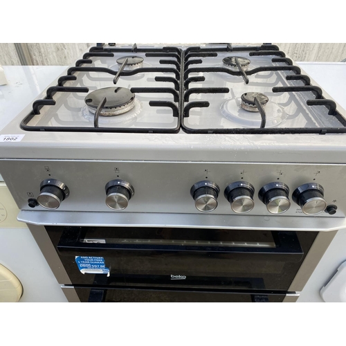 1802 - A SILVER BEKO GAS AND ELECTRIC FREESTANDING OVEN AND HOB BELIEVED WORKING OIRDER BUT NOI WARRANTY