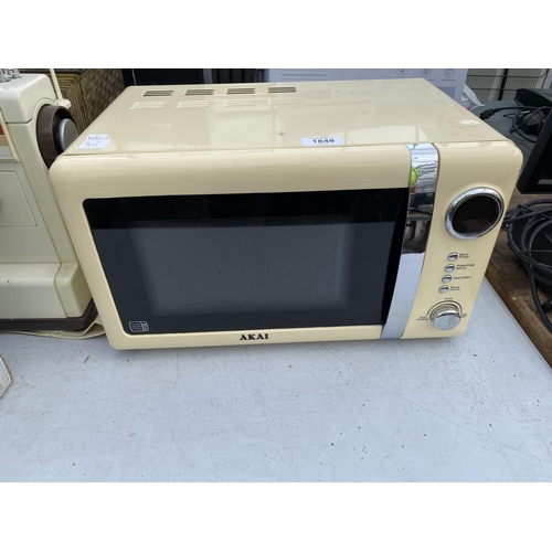 1848 - A CREAM AKAI MICROWAVE OVEN BELIEVED IN WORKING ORDER BUT NO WARRANTY