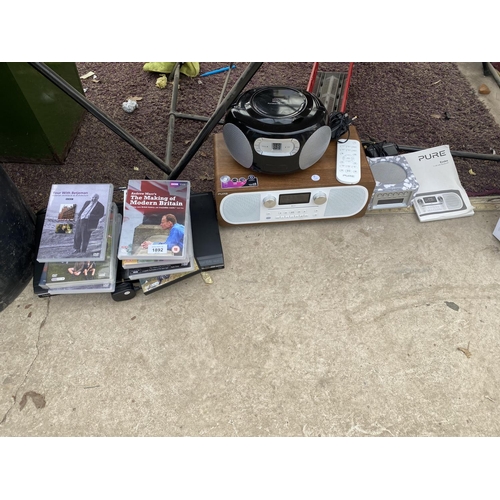 1892 - A TOSHIBA DVD PLAYER AND THREE RADIOS WITH AN ASSORTMENT OF DVDS