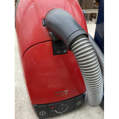 1486 - A SEBO VACUUM AND A FURTHER MIELE HOOVER