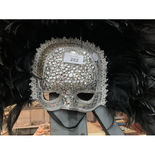 282 - A HIGHLY DECORATIVE SEQUIN MASQUERADE MASK WITH FEATHERS WITH HANGING HOOK