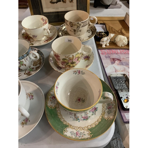 286 - A COLLECTION OF EIGHT EARLY CERAMIC JUMBO CUPS AND SAUCERS