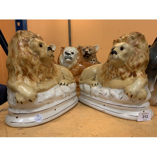 313 - A PAIR OF STAFFORDSHIRE POTTERY LIONS AND THREE FURTHER BIG CAT ORNAMENTS