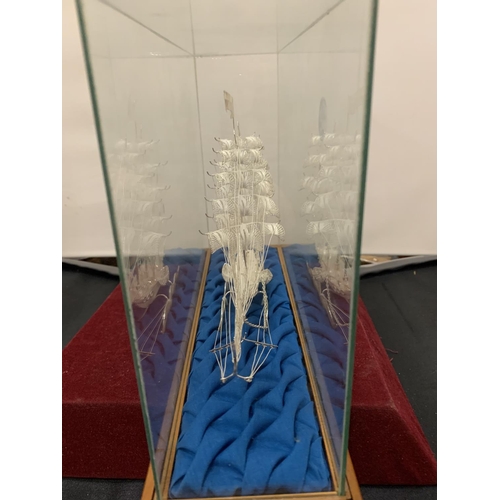 839 - A MODEL OF A GALLEON IN A DISPLAY CASE