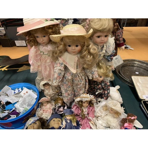 201 - A LARGE COLLECTION OF CHINA DOLLS OF VARYING SIZES