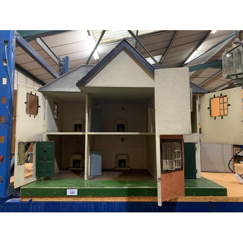 242 - A LARGE VINTAGE DOLLSHOUSE