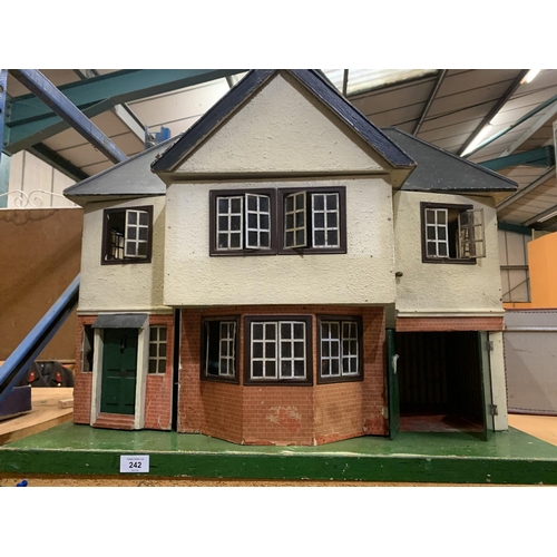 242 - A LARGE VINTAGE DOLLSHOUSE