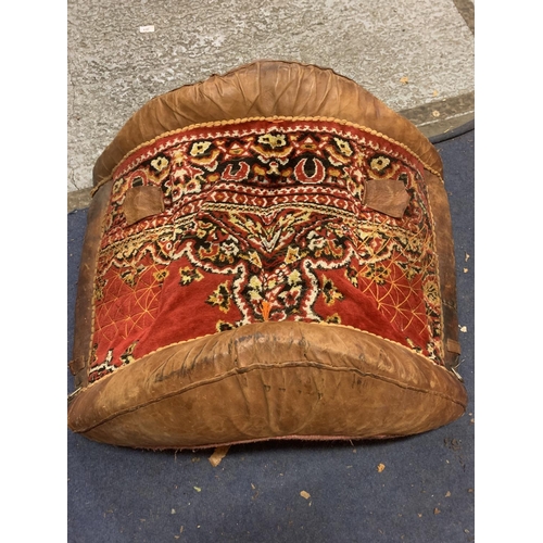 780 - A LARGE LEATHER CAMEL SADDLE WITH WOVEN DETAIL