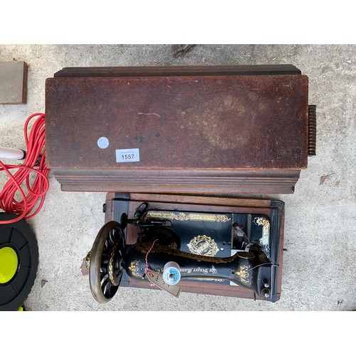 1557 - A VINTAGE SINGER SEWING MACHINE IN A WOODEN CASE