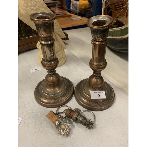 5 - A PAIR OF VINTAGE SILVER PLATED ON COPPER CANDLESTICKS - HEIGHT 21CMS AND TWO WHITE METAL BOTTLE STO... 