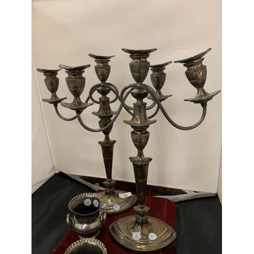 93 - A PAIR OF SILVER PLATED THREE BRANCH CANDELABRAS AND A PAIR OF SMALL URN SHAPED VASES