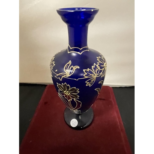 360 - A BLUE GLASS URN WITH GOLD RELIEF FLOWER PATTERN (HEIGHT 26CM)