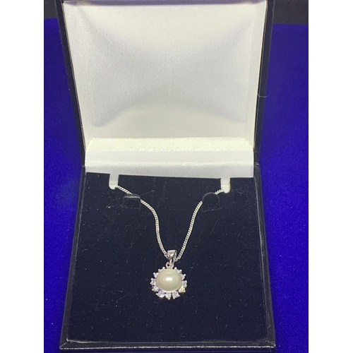 514 - A SILVER CHAIN MARKED 925 WITH A PEARLISED AND CLEAR STONE PENDANT IN A PRESENTATION BOX