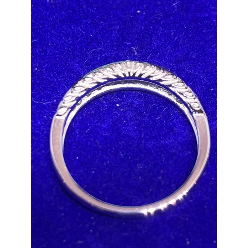 542 - A SILVER RING MARKED 925 WITH INLINE CLEAR STONES SIZE N IN A PRESENTATION BOX