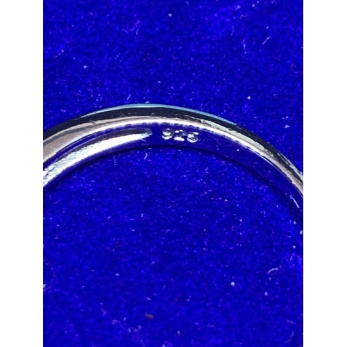 542 - A SILVER RING MARKED 925 WITH INLINE CLEAR STONES SIZE N IN A PRESENTATION BOX