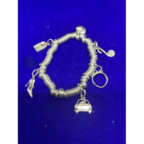 569 - A SILVER LINKS OF LONDON CHARM BRACELET WITH SIX CHARMS IN A PRESENTATION BOX