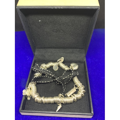 569 - A SILVER LINKS OF LONDON CHARM BRACELET WITH SIX CHARMS IN A PRESENTATION BOX