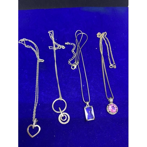 583 - FOUR SILVER NECKLACES WITH PENDANTS