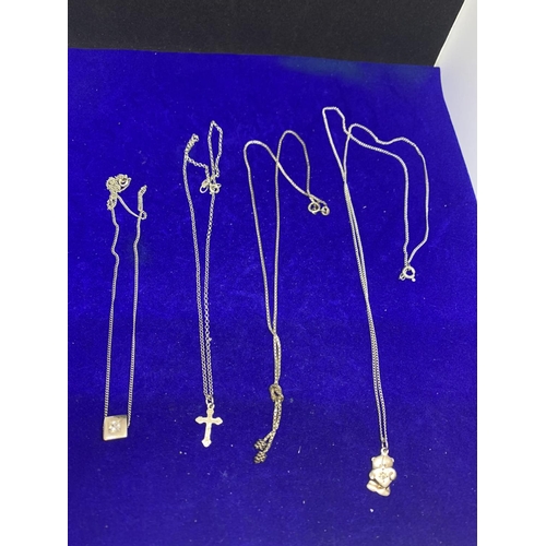 618 - FOUR SILVER NECKLACES MARKED 925 WITH PENDANTS TO INCLUDE A TEDDY, CROSS, CLEAR STONE ETC