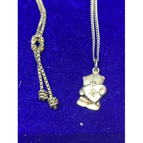 618 - FOUR SILVER NECKLACES MARKED 925 WITH PENDANTS TO INCLUDE A TEDDY, CROSS, CLEAR STONE ETC