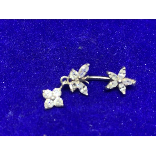 654 - TWO SILVER BELLY BUTTON BARS WITH COLOURED STONE FLOWER DESIGN