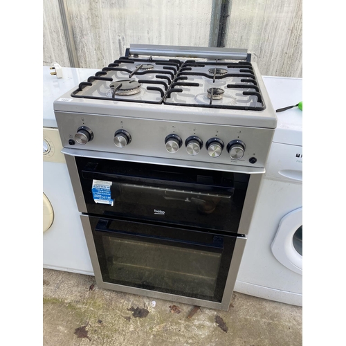 1802 - A SILVER BEKO GAS AND ELECTRIC FREESTANDING OVEN AND HOB BELIEVED WORKING OIRDER BUT NOI WARRANTY