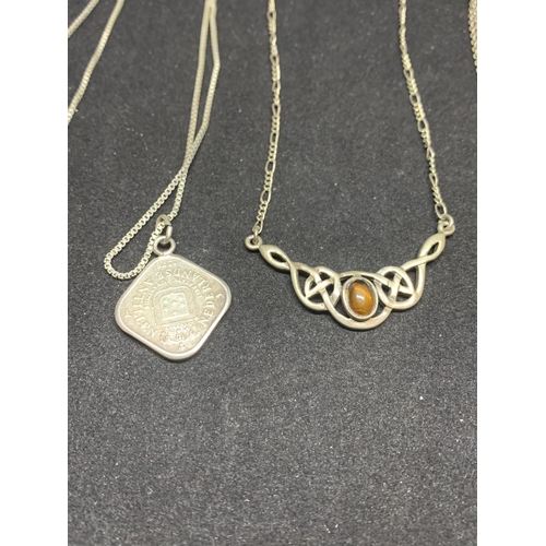 508 - FOUR SILVER NECKLACES MARKED 925 WITH PENDANTS TO INCLUDE A CLEAR STONE CIRCLE, A CELTIC DESIGN, A B... 