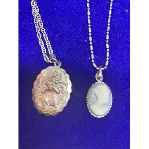 533 - FOUR SILVER NECKLACES WITH PENDANTS TO INCLUDE A ST CHRISTOPHER, BLUE CAMEO, FLOWER ETC