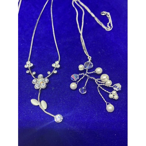 537 - FOUR SILVER NECKLACES MARKED 925 WITH PENDANTS TO INCLUDE A DECORATIVE PEARL DESIGN, CLEAR STONE FLO... 